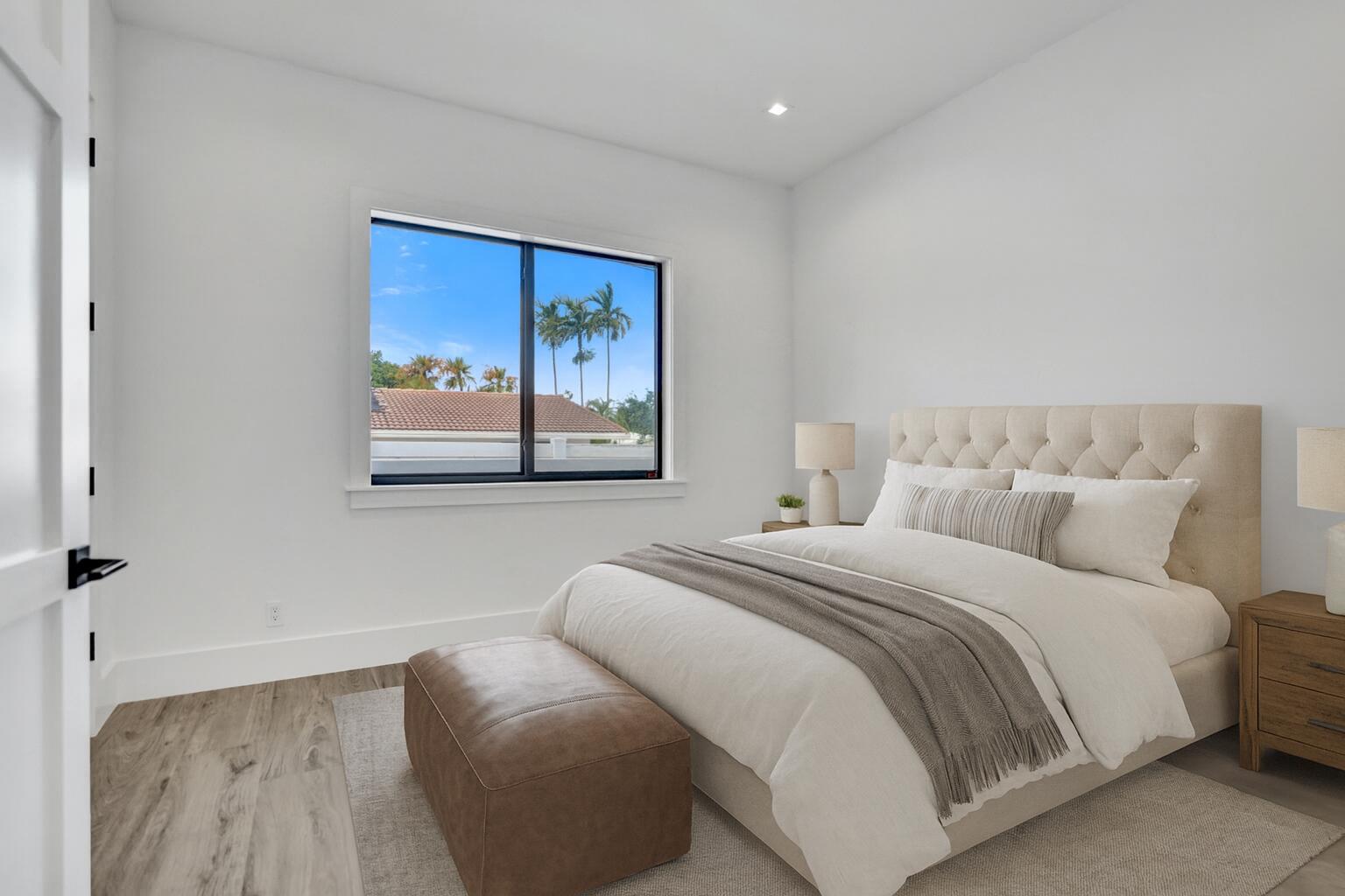 4451 Northeast 27th Terrace Lighthouse Point, FL 33064 - Photo 24 of 38 a bedroom with a bed and a painting on the wall