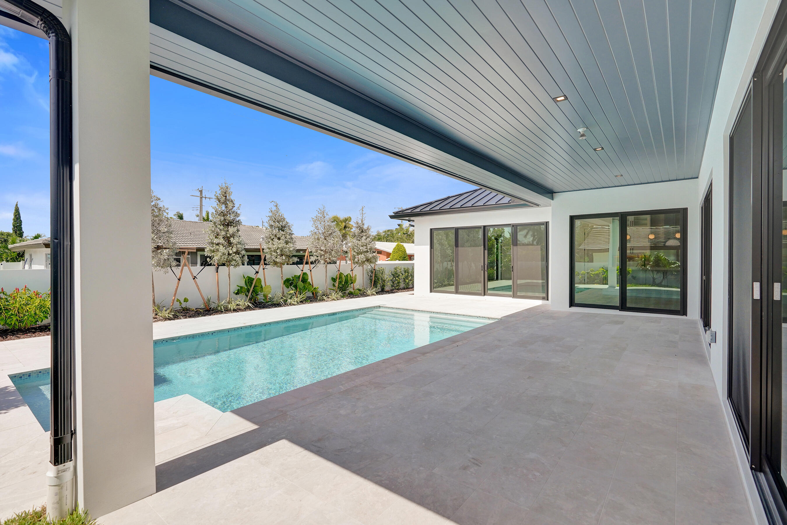 4451 Northeast 27th Terrace Lighthouse Point, FL 33064 - Photo 29 of 38 a view of a porch with a floor to ceiling window and yard