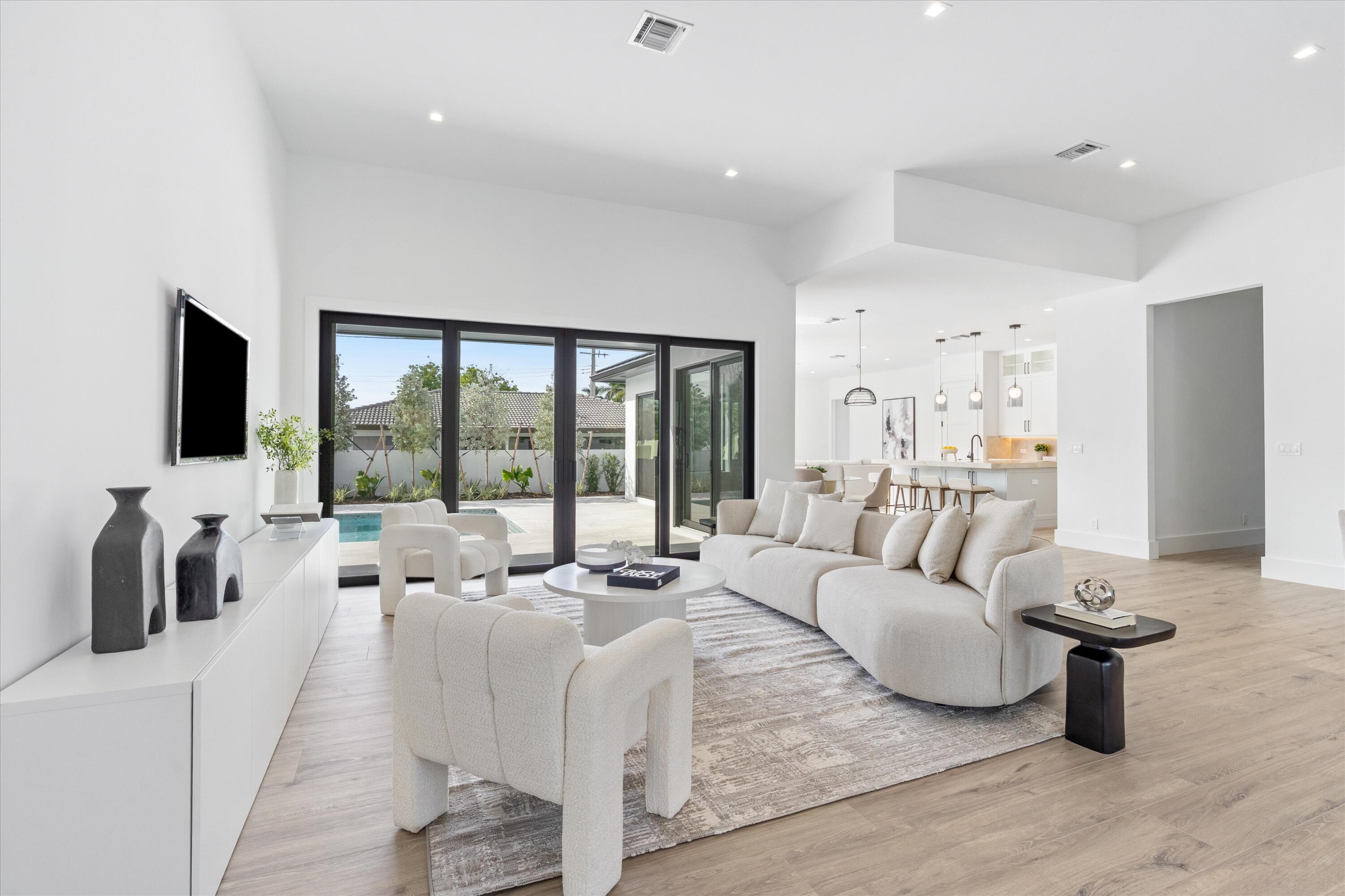 4451 Northeast 27th Terrace Lighthouse Point, FL 33064 - Photo 4 of 38 a living room with furniture and a flat screen tv