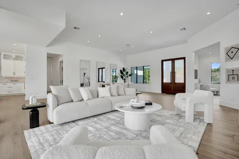 a living room with furniture and a floor to ceiling window