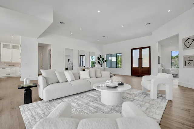 a living room with furniture and a floor to ceiling window