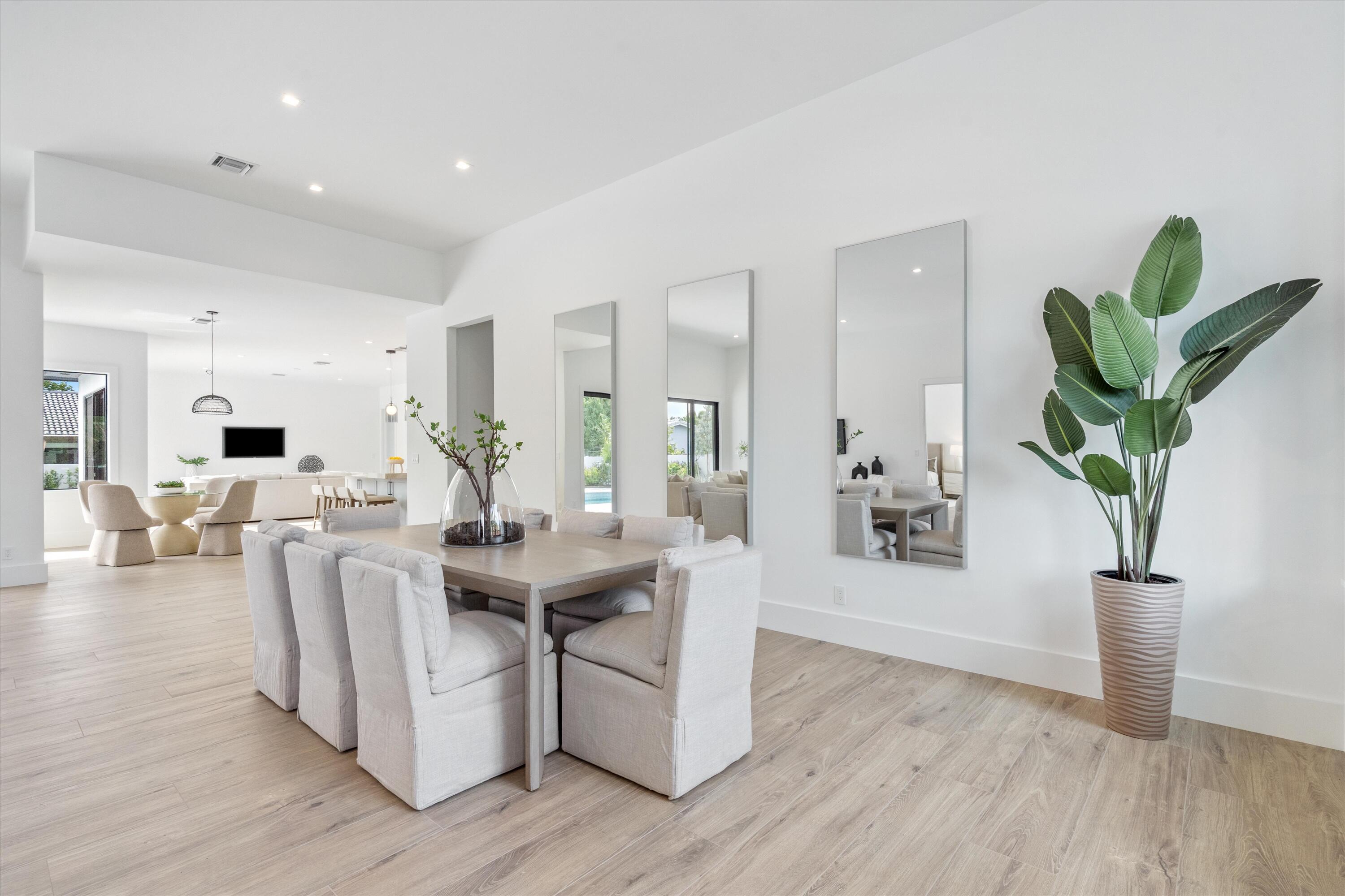 4451 Northeast 27th Terrace Lighthouse Point, FL 33064 - Photo 9 of 38 a view of a dining room with furniture and wooden floor