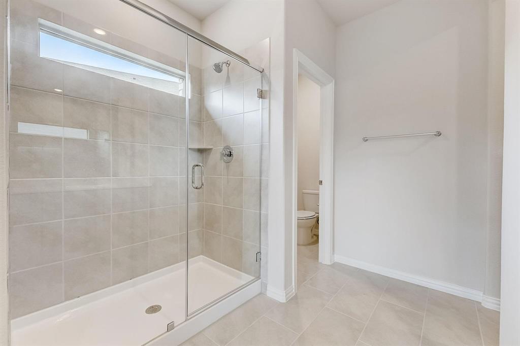 1405 Winters Way McKinney, TX 75071 - Photo 22 of 32 Bathroom featuring tile patterned flooring, an enclosed shower, and toilet