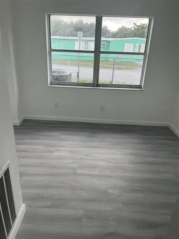 a view of an empty room with a window