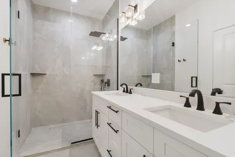 a bathroom with a sink double vanity and shower
