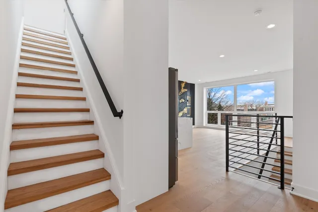 a view of a hallway with stairs and a fireplace