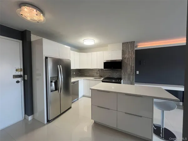 a kitchen with cabinets and stainless steel appliances