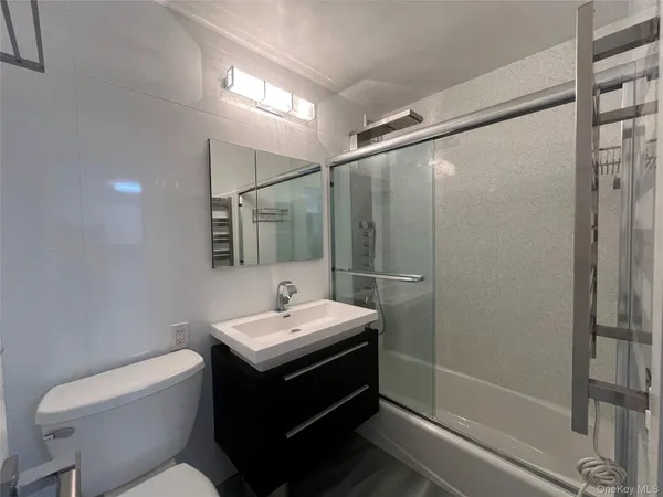 a bathroom with a sink toilet and shower