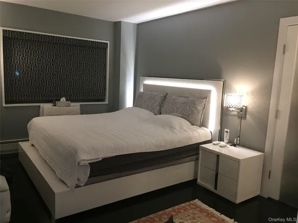 a bedroom with a bed and a mirror