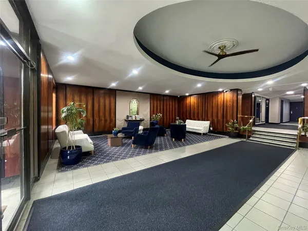 a lobby with furniture and a chandelier