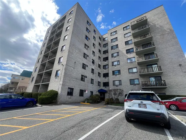 a view of a car parked in front of a building