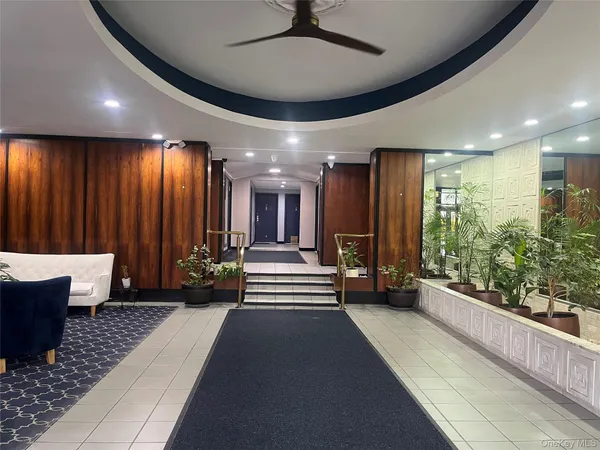 a lobby with furniture and a large window