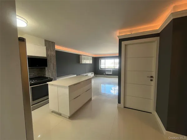 a kitchen with stainless steel appliances granite countertop a stove and a refrigerator