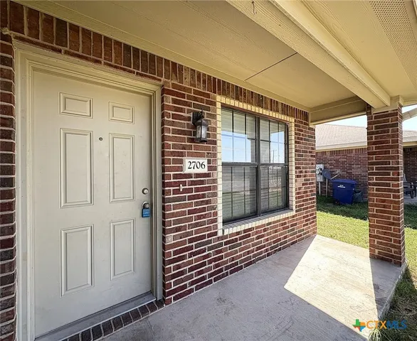 a view of a porch with a door and a large window