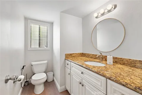 a bathroom with a toilet a sink and a mirror