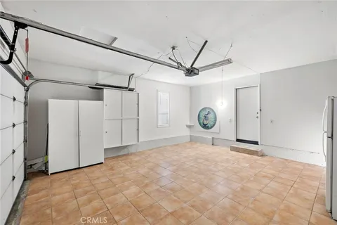 a view of a room with a ceiling fan and wooden floor