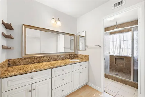a bathroom with a granite countertop sink mirror and