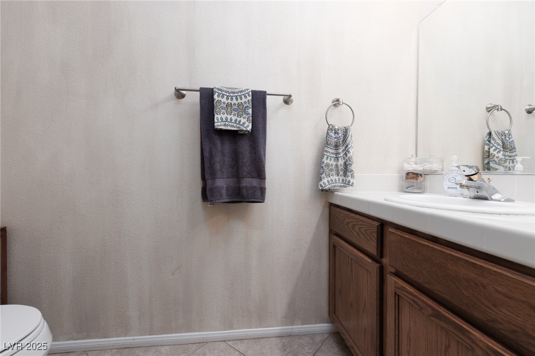 99 Milicity Road Henderson, NV 89012 - Photo 19 of 51 Bathroom featuring vanity and light tile patterned flooring