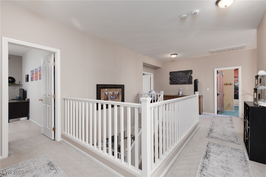 99 Milicity Road Henderson, NV 89012 - Photo 22 of 51 Hallway featuring an upstairs landing and light colored carpet