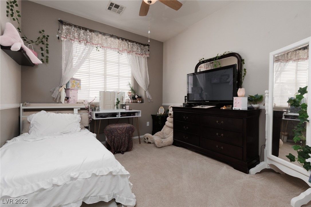 99 Milicity Road Henderson, NV 89012 - Photo 24 of 51 Carpeted bedroom with multiple windows and a ceiling fan