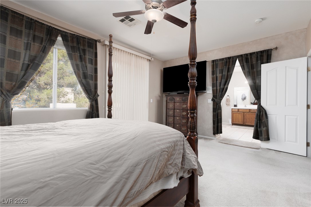 99 Milicity Road Henderson, NV 89012 - Photo 29 of 51 Bedroom with carpet floors, a ceiling fan, access to exterior, and ensuite bath