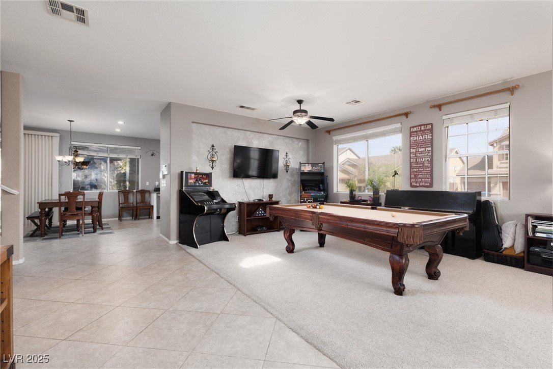 Playroom featuring pool table, plenty of natural light, light tile patterned floors, and ceiling fan