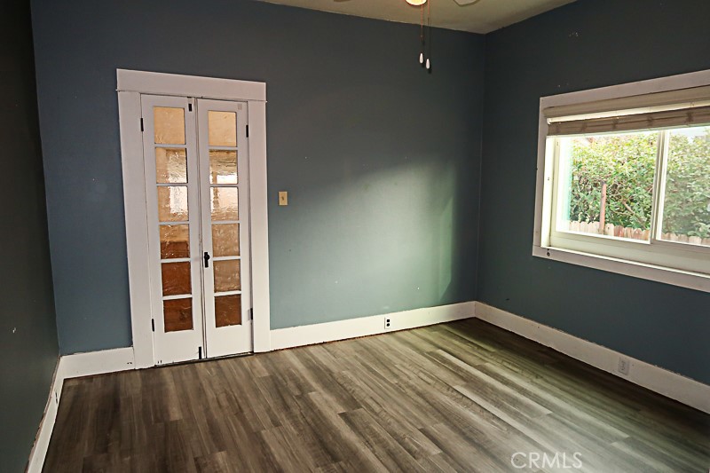 1239 Broadway Street Chico, CA 95928 - Photo 23 of 36 a view of an empty room with wooden floor and a window