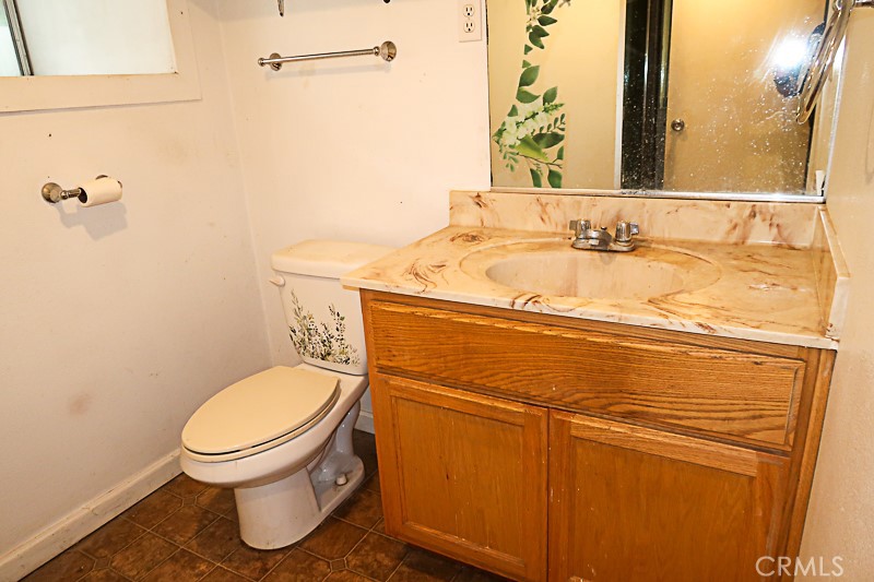 1239 Broadway Street Chico, CA 95928 - Photo 26 of 36 a bathroom with a granite countertop toilet and a sink