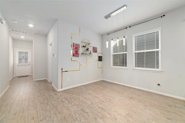 a kitchen with a refrigerator and cabinets