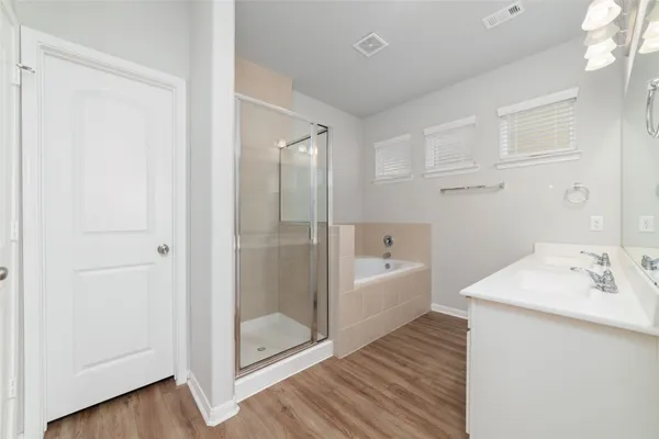 a spacious bathroom with a double vanity sink and mirror