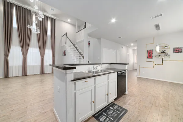 a kitchen with stainless steel appliances granite countertop a stove and a sink