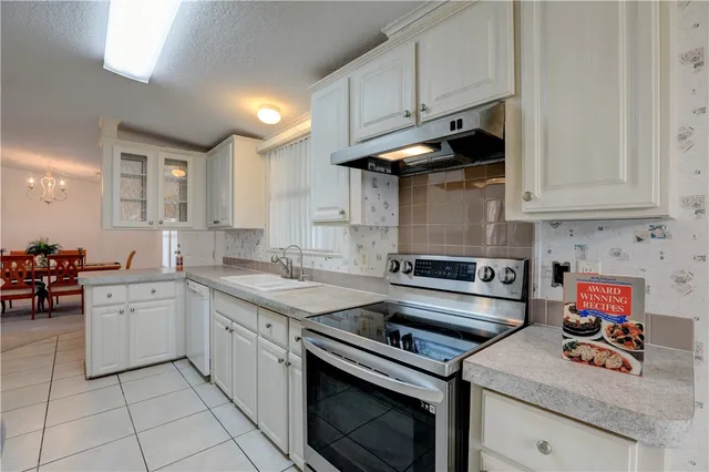 a kitchen with stainless steel appliances granite countertop a refrigerator sink and cabinets
