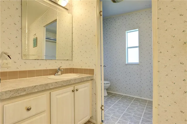 a bathroom with a granite countertop sink a mirror and a