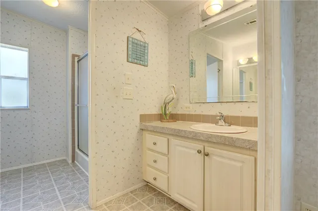 a bathroom with a glass shower door