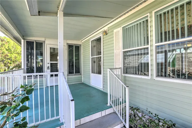 a view of a house with backyard and porch