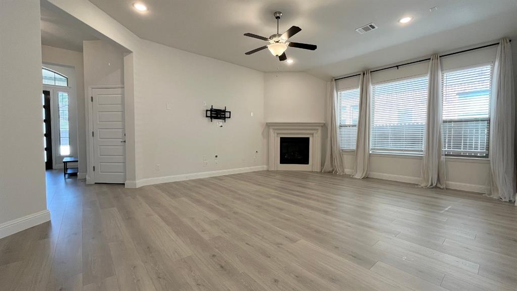 5304 Babcock Road McKinney, TX 75071 - Photo 9 of 27 wooden floor in an empty room with a fireplace