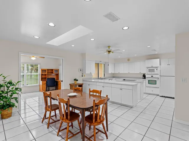 a kitchen with stainless steel appliances kitchen island granite countertop a sink and cabinets