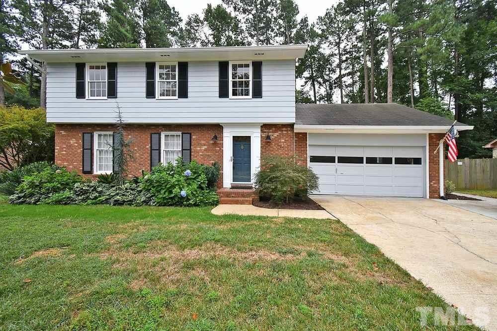 6405 Wrenwood Avenue Raleigh, NC 27607 - Photo 1 of 30 a house that has a tree in front of the house