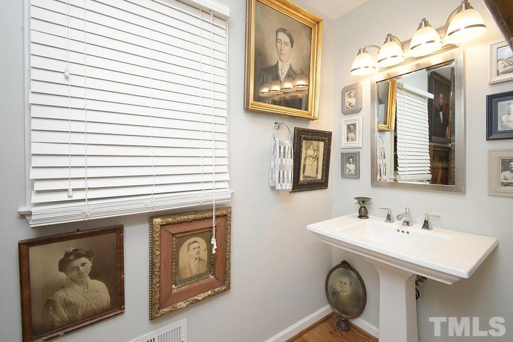 6405 Wrenwood Avenue Raleigh, NC 27607 - Photo 12 of 30 a bathroom with a sink and a mirror