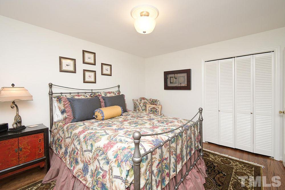 6405 Wrenwood Avenue Raleigh, NC 27607 - Photo 16 of 30 a bedroom with a bed and a lamp on dresser