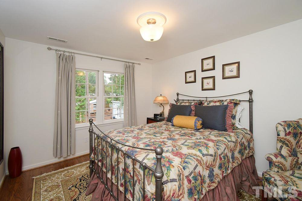 6405 Wrenwood Avenue Raleigh, NC 27607 - Photo 17 of 30 a bedroom with double bed and a window