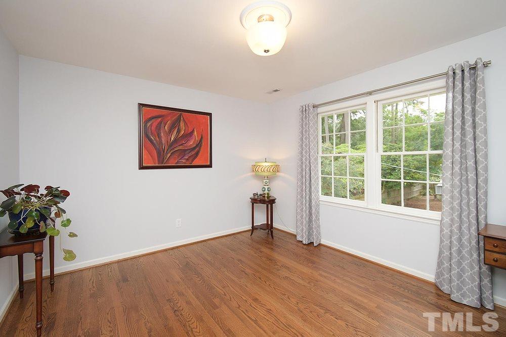 6405 Wrenwood Avenue Raleigh, NC 27607 - Photo 19 of 30 a view of empty room with wooden floor and fan