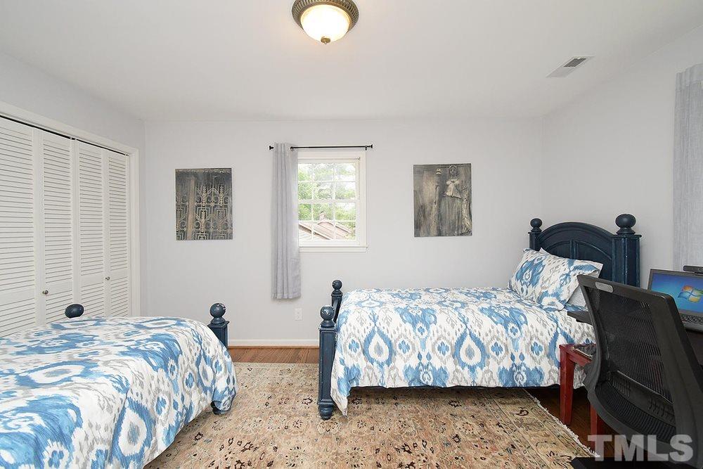6405 Wrenwood Avenue Raleigh, NC 27607 - Photo 20 of 30 a bedroom with double bed and a window