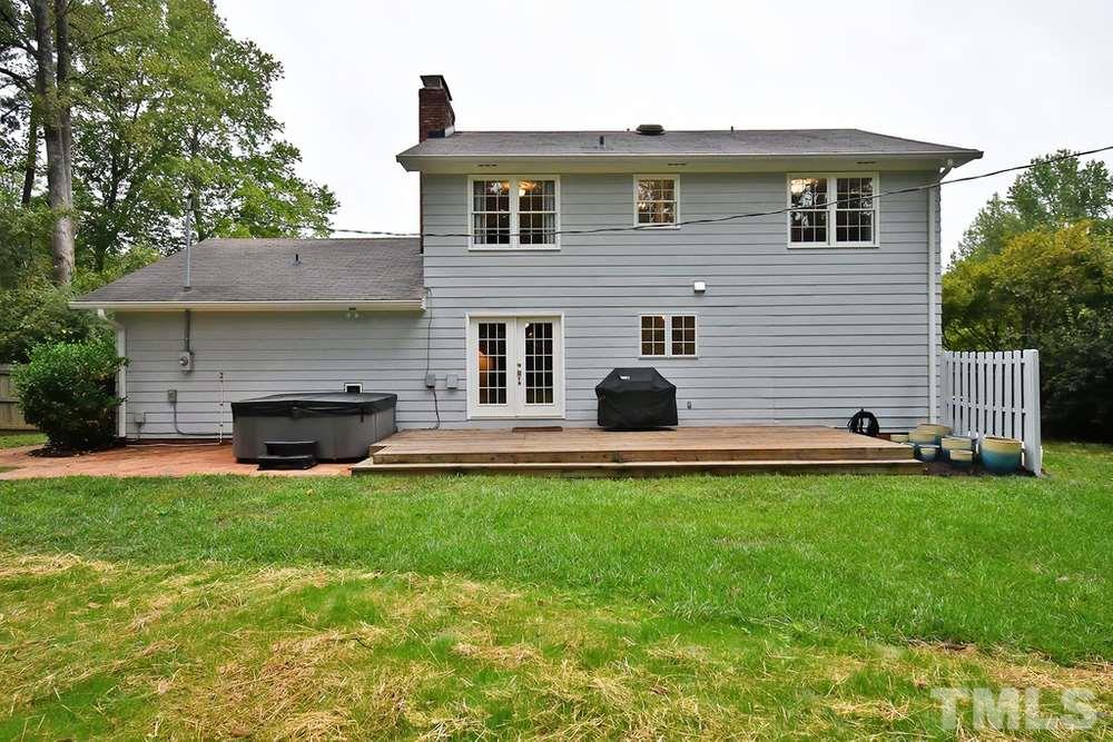 6405 Wrenwood Avenue Raleigh, NC 27607 - Photo 22 of 30 a view of a house with a yard and a fireplace