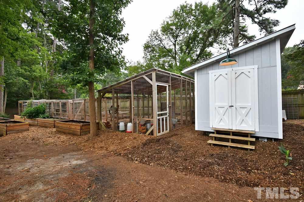 6405 Wrenwood Avenue Raleigh, NC 27607 - Photo 27 of 30 a view of backyard with wooden fence and a large tree