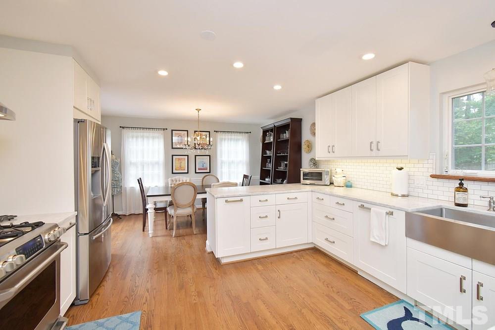 6405 Wrenwood Avenue Raleigh, NC 27607 - Photo 7 of 30 a large white kitchen with stainless steel appliances
