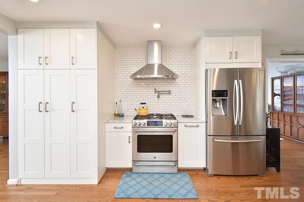 6405 Wrenwood Avenue Raleigh, NC 27607 - Photo 8 of 30 a kitchen with stainless steel appliances granite countertop a refrigerator and a stove