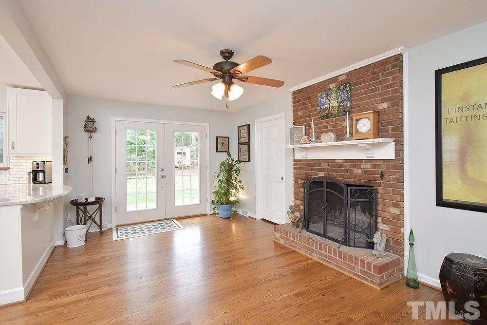 6405 Wrenwood Avenue Raleigh, NC 27607 - Photo 10 of 30 a view of a livingroom with a fireplace and window