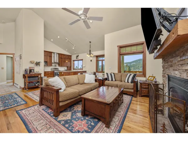 a living room with furniture a fireplace and a flat screen tv