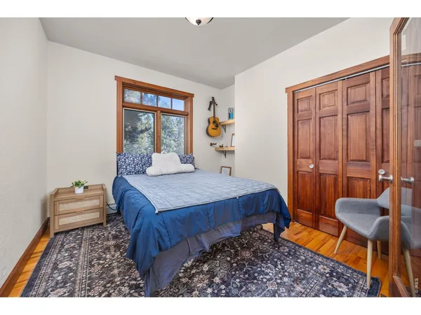 a spacious bedroom with a bed a table and chair